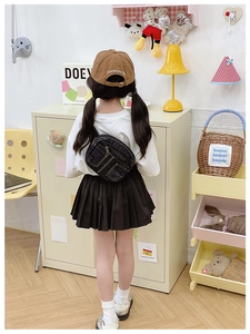 Détail d'un sac bandoulière en denim bleu foncé pour enfant avec tenue décontractée