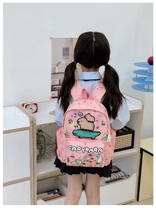 Pink kids backpack detail with cute Capybara cartoon print and multi-pocket design