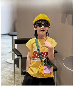 Kids streetwear style featuring yellow t-shirt, knitted beanie and matching crossbody bag