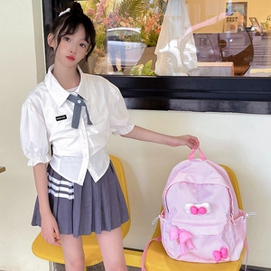 Pink plaid backpack with cute bows for kids, styled with casual JK school uniform