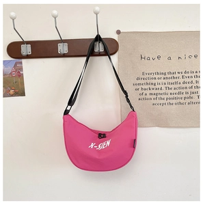 Close-up of pink hobo-style crossbody bag featuring X-SIEN letter print and black zipper