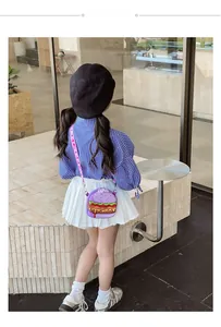 Rear view of a child wearing a cute purple hamburger-shaped silicone crossbody bag