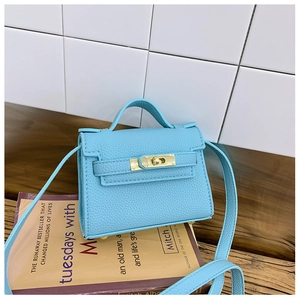 Detail of light blue mini satchel featuring pebble grain leather and golden metal clasp