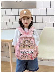 Pink toddler backpack with cute Capybara cartoon print shown on a child for scale