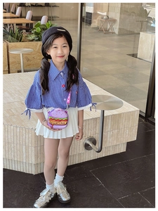 Close-up of a purple hamburger-shaped silicone mini crossbody bag for kids' outfit