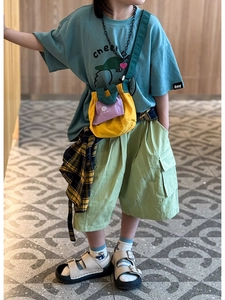 Detail of kids casual crossbody bag with contrast colors and utility cargo shorts