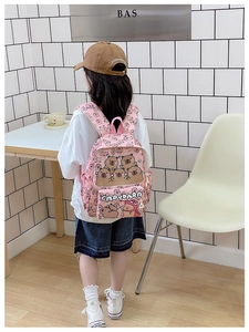 Toddler girl wearing pink Capybara backpack featuring cute cartoon prints and side pockets