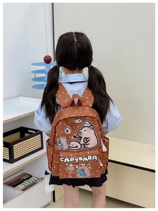 Detail of cute Capybara print on kids brown polka dot backpack with side pocket