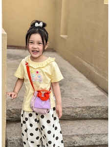Kids colorful drawstring crossbody bag styled with a pleated texture and sun print