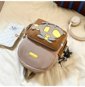Close-up of cute cartoon airplane kids backpack with durable nylon fabric in brown and beige