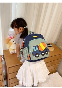 Detail view of child wearing 3D cement mixer backpack with mesh side pocket
