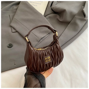 Macro detail of coffee brown hobo bag with vertical pleats and golden hardware