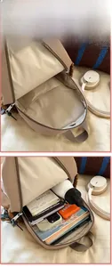 Detail view of khaki backpack interior showing storage for water bottle, books and tablet