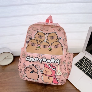 Detailed view of pink capybara pattern backpack with side bottle pocket on a wooden desk