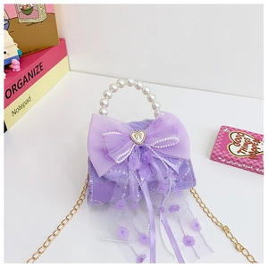 Détail du sac à main violet pour enfant avec nœud en dentelle et poignée en perles