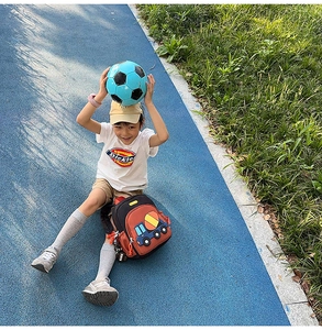 Boy with a large capacity school backpack featuring a blue cement truck cartoon embroidery