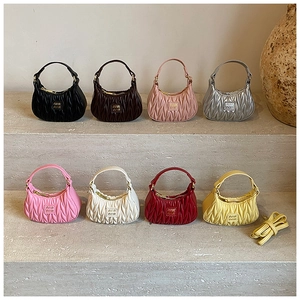 Detailed display of colorful mini pleated handbags with top handles and shoulder straps