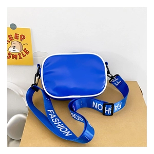 Detail of blue kid's sporty crossbody bag featuring contrast white piping and wide logo strap