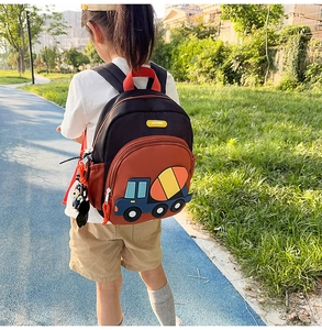 Close-up of the 3D construction truck patch and durable fabric on this kids backpack