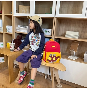 Detail of kids backpack with colorful cartoon helicopter embroidery and side mesh pocket