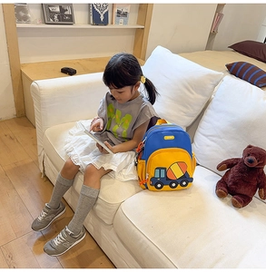 Detail of cartoon excavator kids backpack with yellow and blue contrast stitching design