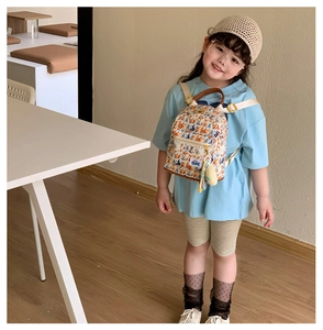 Toddler backpack with fox and forest prints featuring a cute yellow plush charm