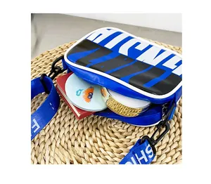 Internal storage view of blue contrast shoulder bag holding notebooks and makeup items