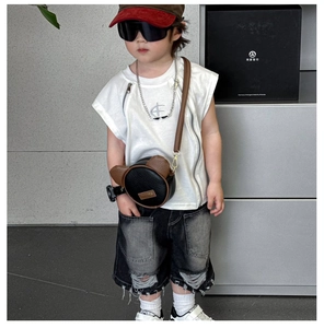 Kid's mini bear-shaped crossbody bag shown on a stylish toddler outdoor outfit