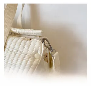 Close-up of durable metal hook and quilted fabric on the beige bear diaper bag