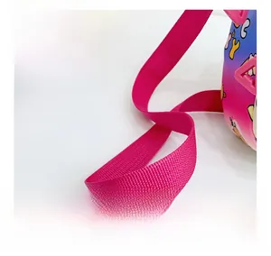 Detail of pink gradient crossbody bag showing durable nylon strap and cute bear prints
