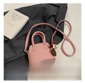 Pink lychee texture mini handbag for girls featuring a cute puppy plush charm detail