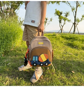 Detail of kids backpack with 3D cartoon cement mixer patch on durable canvas fabric