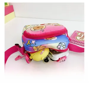 Detail showing the internal storage capacity of the cartoon crossbody bag with two zippers