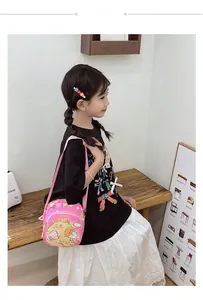 Detailed side view of pink kids crossbody bag featuring cute cartoon bear printing
