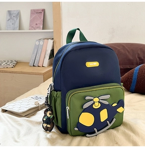 Detail view of cartoon helicopter backpack for kids with a cute plush bear charm hanger
