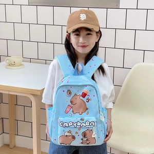 Blue kids backpack featuring cute capybara prints shown on a model in a school setting