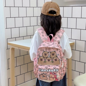 Pink toddler backpack with cartoon capybara prints and 3D embroidery on a child model
