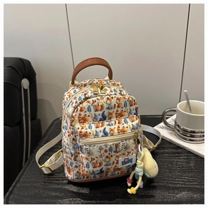 Mini cartoon backpack for toddlers with fox forest prints and a plush ball charm detail