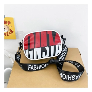 Detail of red and black color-block crossbody bag with white piping and logo strap