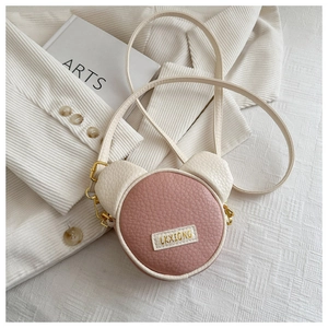 Close-up of pink and beige mini bear shoulder bag with high-quality PU leather texture