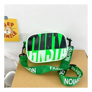 Detail of green sporty crossbody bag with bold letters and adjustable fashion strap
