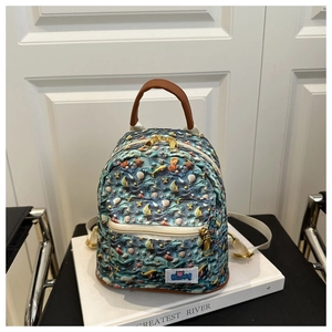 Detail of mini ocean theme backpack showing marine patterns and golden metal zipper