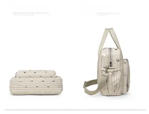 Side and bottom view of quilted beige diaper bag with silver polka dots and zip pocket