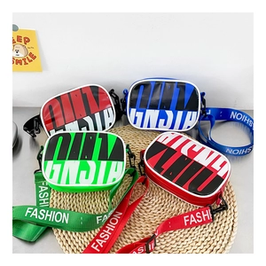 Detail of four colorful mini crossbody bags with FASHION printed wide straps