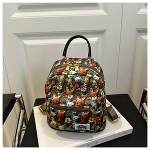 Detailed macro view of mini cartoon backpack with colorful crochet pattern and gold hardware