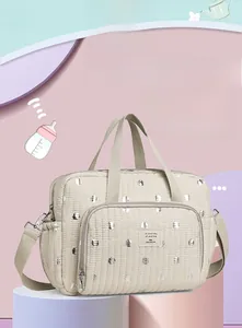 Detail of quilted mummy bag featuring adjustable straps and silver reflective accents
