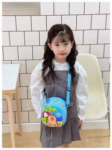 Detailed view of the cute blue Capybara cartoon crossbody bag worn by a child
