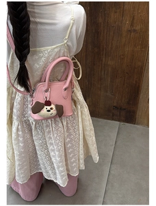 Pink mini crossbody bag for girls with cute puppy plush charm and adjustable strap