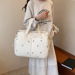 Quilted white tote bag with floral embroidery and large capacity for baby essentials