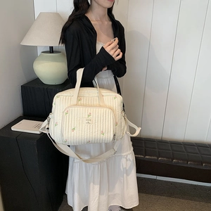 Quilted cream mommy bag with pink tulip embroidery and adjustable crossbody strap